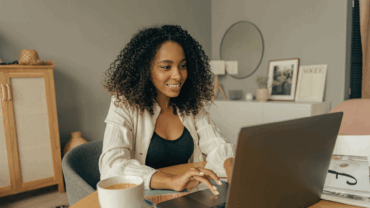 Woman typing on her computer looking for a new job