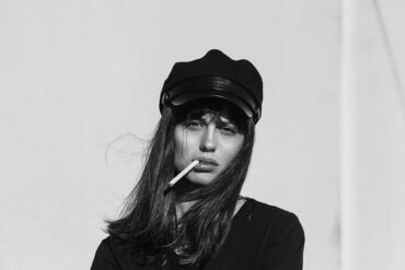 Black and white photo of a beautiful woman model smoking.